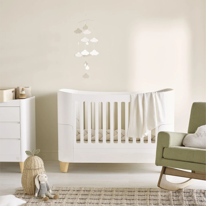 Nursery room with Serena Cot bed with natural legs, matching dresser and rocking chair.