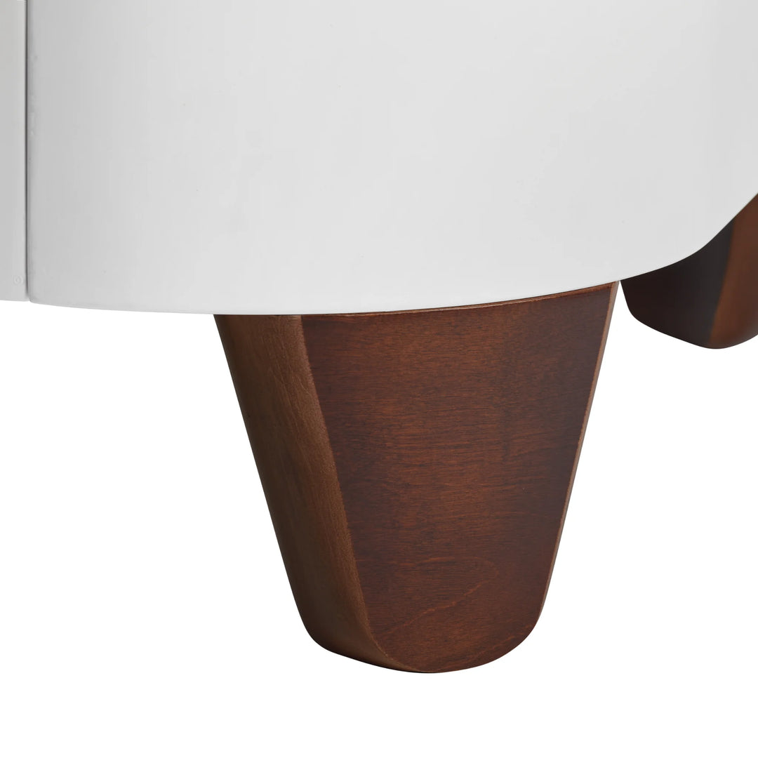 Close-up of the Walnut wood leg on the Serena Cot Bed.