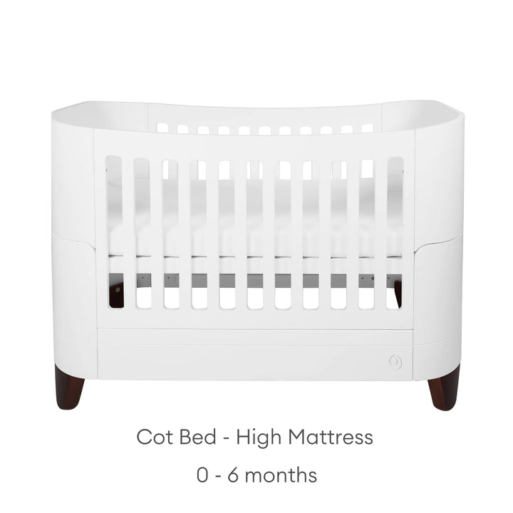 Serena Cot Bed with walnut legs on white background with text: Cot Bed - High Mattress, 0 - 6 months.