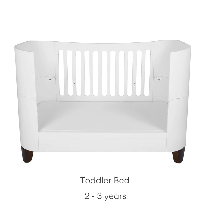 Serena Cot Bed with walnut legs on white background with text: Toddler Bed, 2 - 3 years.