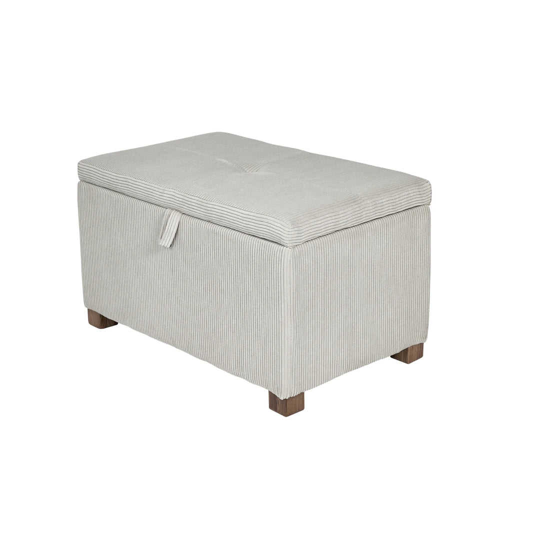 The Gaia Baby Serena Footstool in ecru corduroy fabric shown as a hero product shot on a white background, featuring a soft upholstered storage ottoman with textured corduroy finish and dark wooden feet.