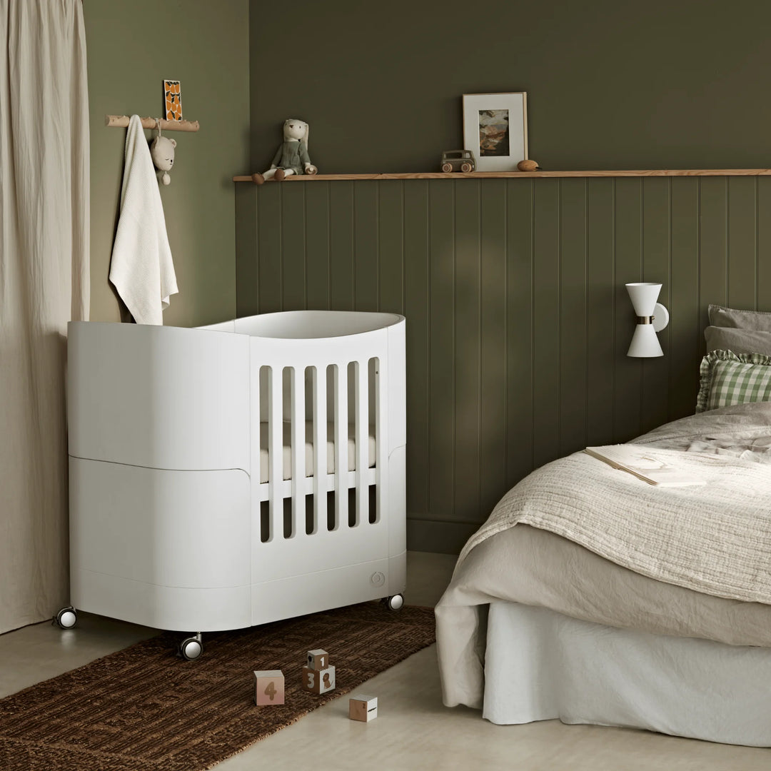 Serena mini cot on wheels in parents room.