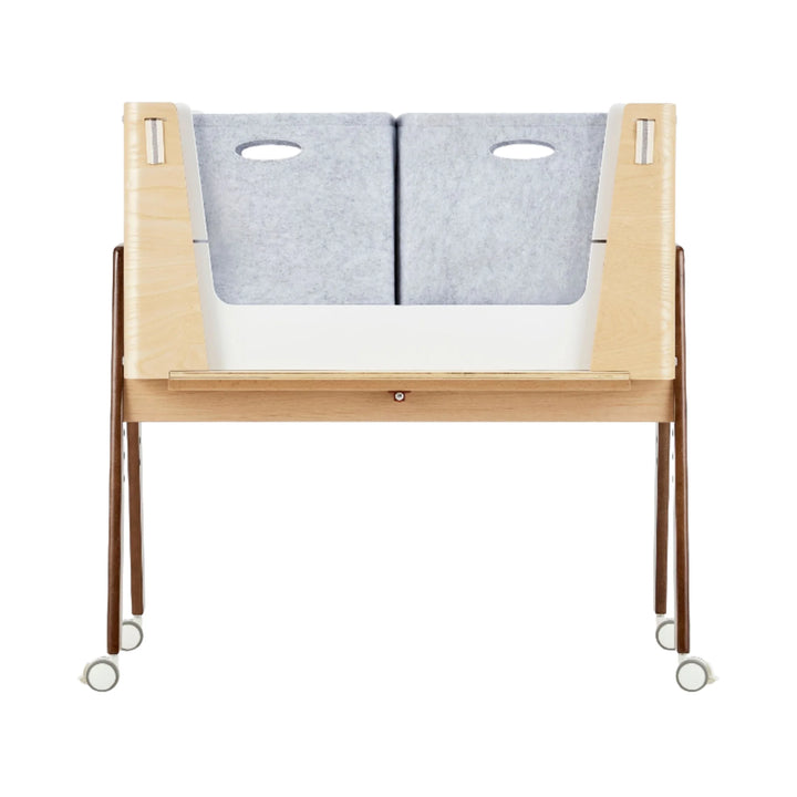 Gaia Baby Hera Bedside Crib converted into a storage unit with two grey felt storage boxes, showcasing the crib’s extended-life design, eco-friendly materials and stylish natural wood finish for organised modern nursery spaces.