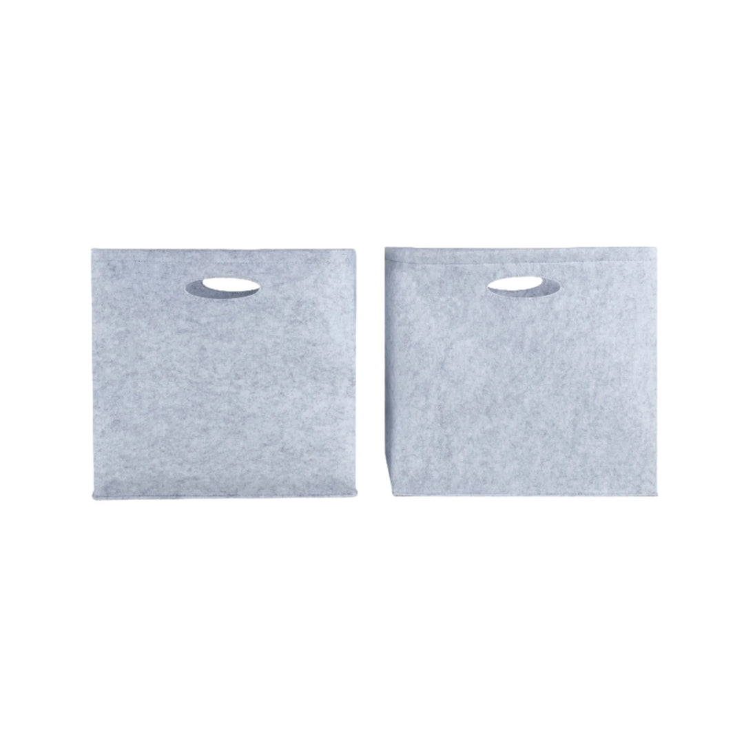 Set of two Gaia Baby Hera Bedside Crib felt storage boxes in soft grey, featuring cut-out carry handles and durable eco-friendly construction, designed to fit perfectly inside the Hera crib storage conversion for organised nursery essentials.