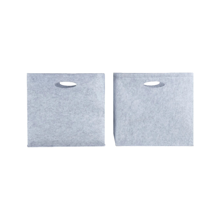 Set of two Gaia Baby Hera Bedside Crib felt storage boxes in soft grey, featuring cut-out carry handles and durable eco-friendly construction, designed to fit perfectly inside the Hera crib storage conversion for organised nursery essentials.