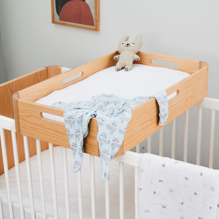 Gaia Baby Hera Changing Station Natural Wood Colour lifestyle image used over a cot bed
