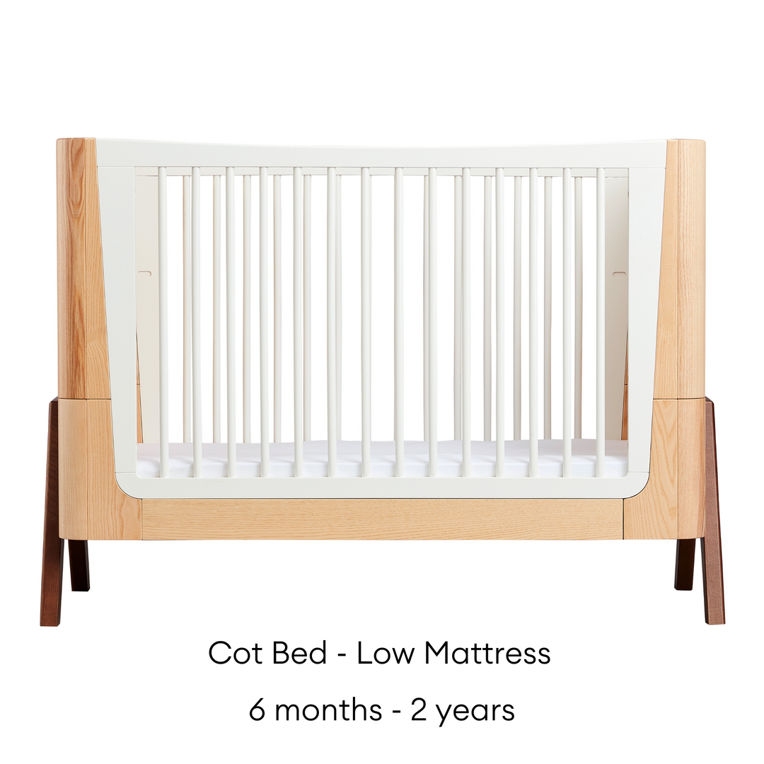 Hera Cot Bed in Natural Ash and Walnut on low mattress setting suitable from six months to two years