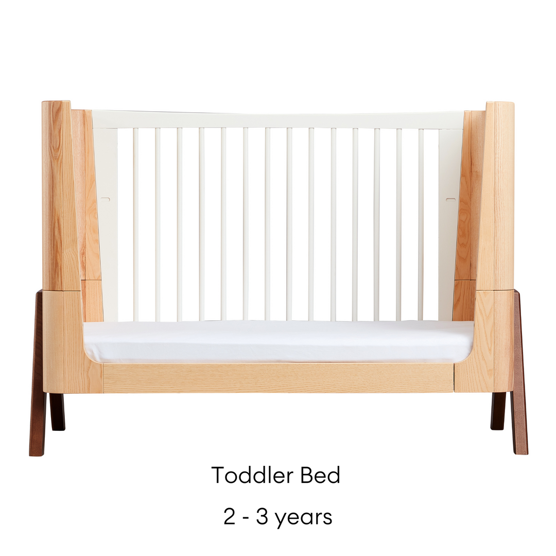 Hera Cot Bed in Natural Ash and Walnut transformed into a Toddler Bed
