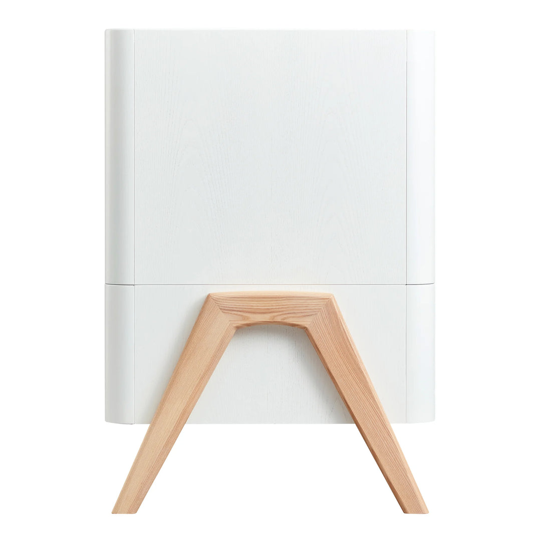 Side view of Gaia Baby Hera cot bed in Scandi White with natural solid wood A-frame legs, showcasing curved Scandinavian design and premium sustainable nursery furniture craftsmanship.