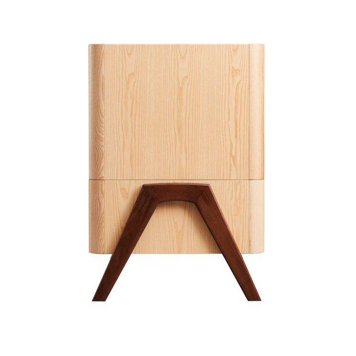 Side view of the Gaia Baby Hera dresser in ash and walnut, showcasing natural wood grain panels and signature angled solid walnut A-frame legs — premium Scandinavian nursery furniture design.