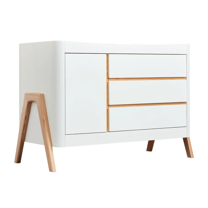 Gaia Baby Hera dresser in natural Scandi white finish, featuring minimalist modern design with three smooth-glide drawers, soft-close cabinet door, and solid wood A-frame legs — stylish Scandinavian nursery storage furniture.