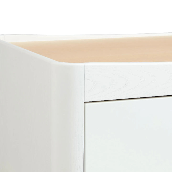 Close-up of the Gaia Baby Hera dresser in Scandi white and natural wood, highlighting the solid ash A-frame leg design and smooth curved edge detailing.