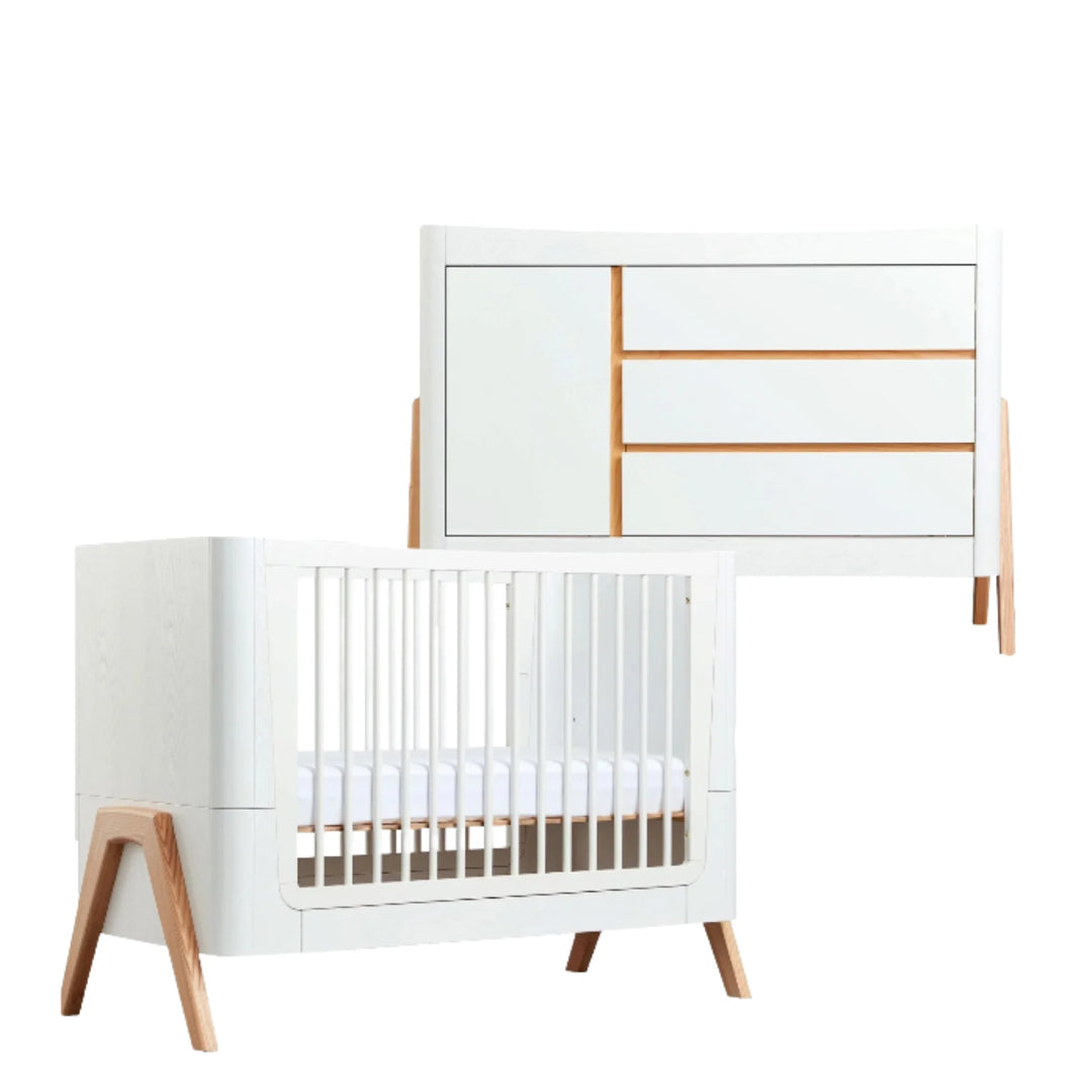 Gaia Baby Hera dresser and cot set in Natural Scandi White, featuring a modern white dresser with natural wood trim and matching white Hera cot bed with angled wooden legs; premium Scandinavian-inspired eco-friendly nursery furniture for contemporary baby room design.