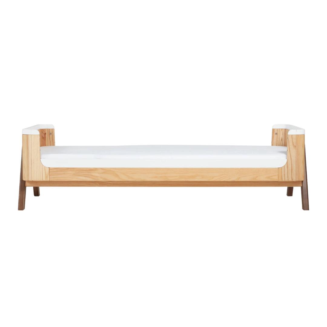 Gaia Baby Hera junior bed extension in natural ash and walnut, extended low toddler bed configuration with minimalist Scandinavian design.