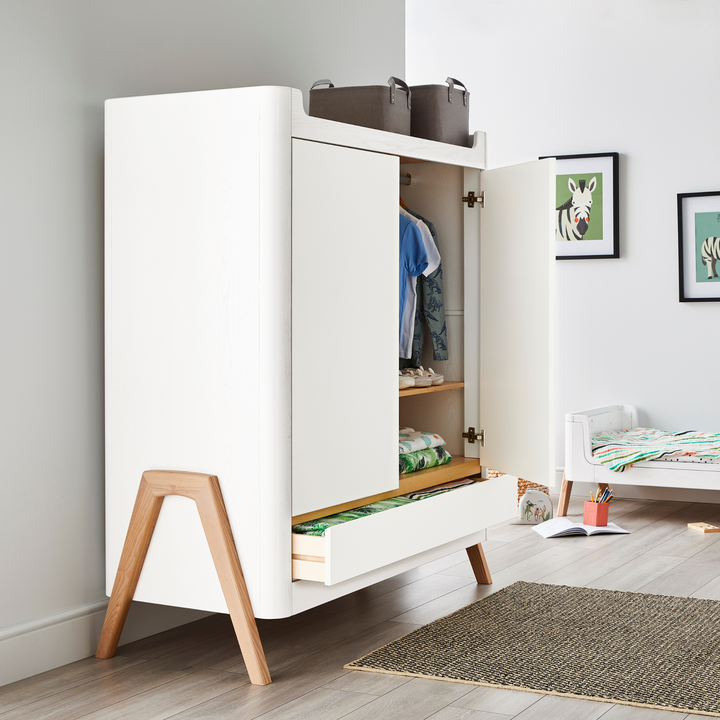 lifestyle image of Gaia Baby Hera Wardrobe in Scandi White and Natural in a teenager room. doors and bottom drawer open. 
