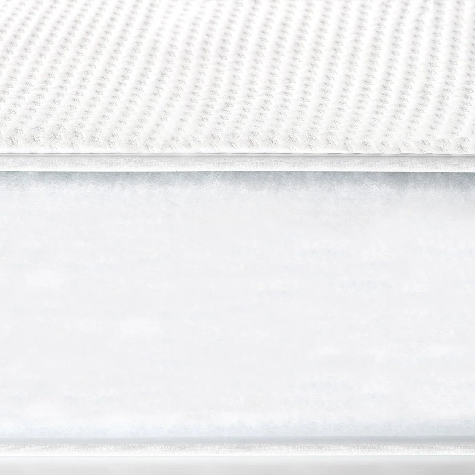 Close-up of Gaia Baby Serena cot bed mattress showing breathable textured surface