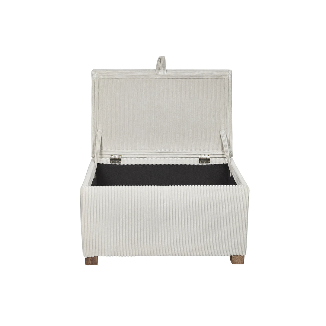 The Gaia Baby Serena Footstool in ecru corduroy fabric shown with the lid open on a white background, featuring a soft upholstered storage ottoman with spacious interior compartment, textured corduroy finish, and wooden feet.