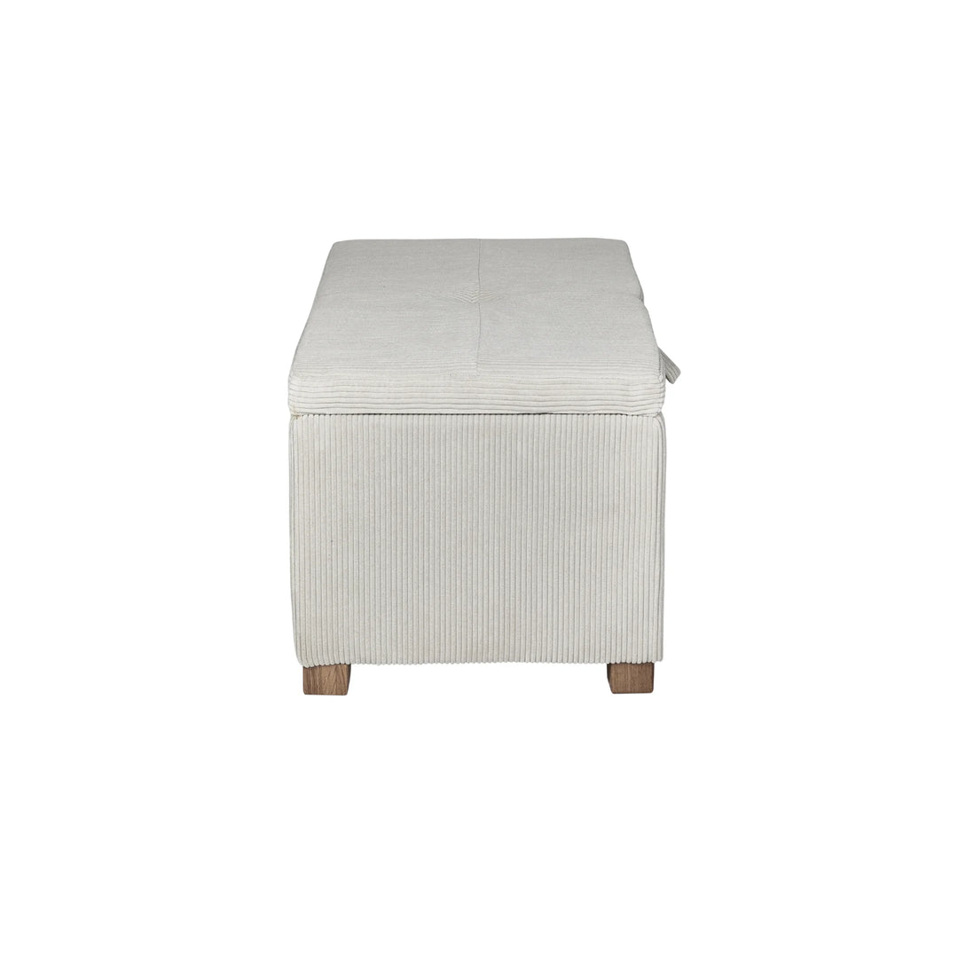The Gaia Baby Serena Footstool in ecru corduroy fabric shown from the side on a white background, featuring a compact upholstered storage ottoman with textured corduroy finish and wooden feet.