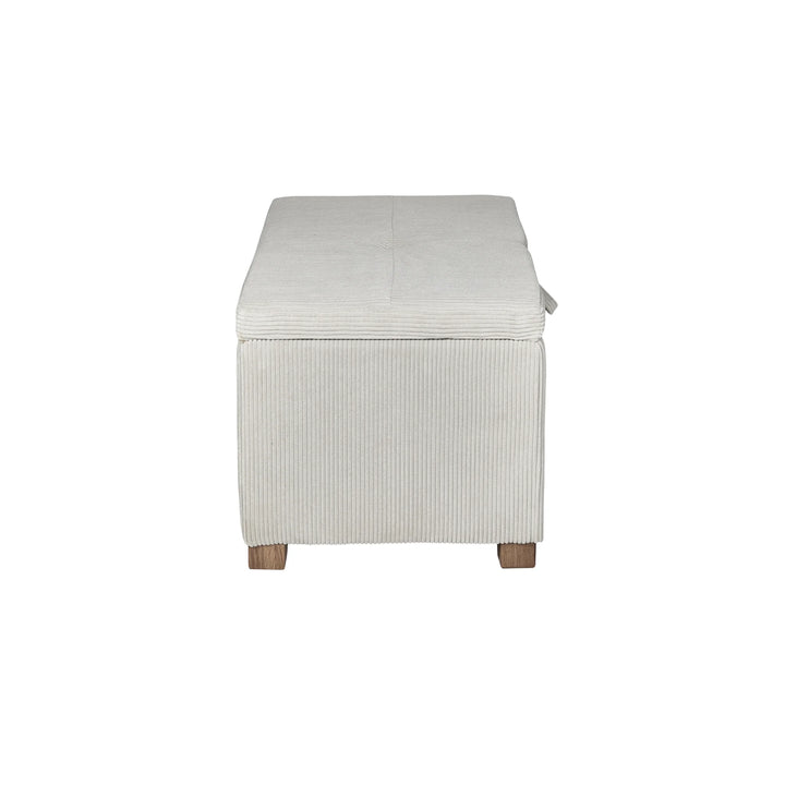 The Gaia Baby Serena Footstool in ecru corduroy fabric shown from the side on a white background, featuring a compact upholstered storage ottoman with textured corduroy finish and wooden feet.