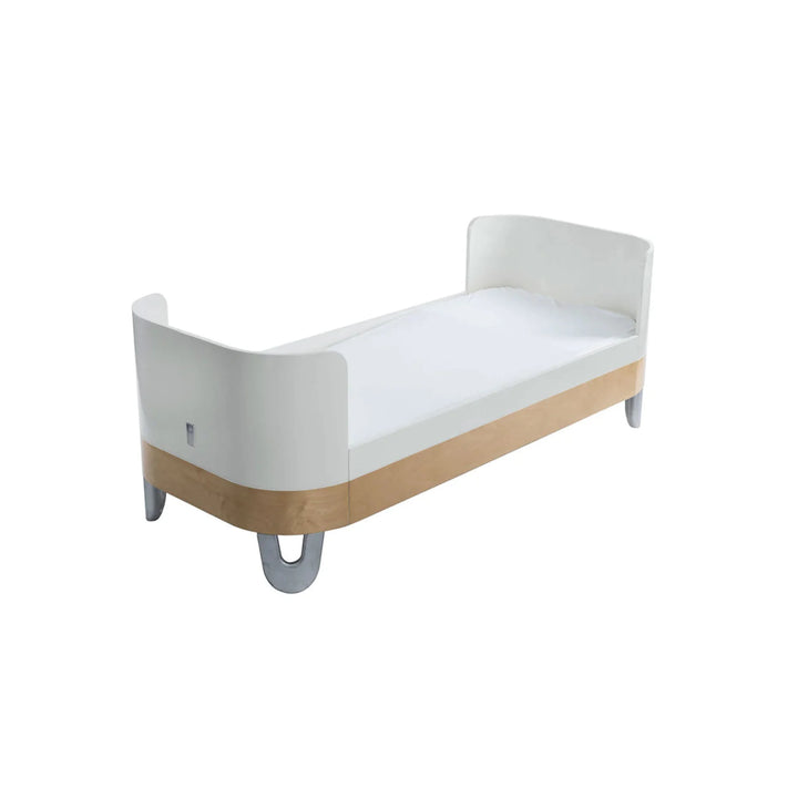 Gaia Baby Serena Junior Bed Extension in white and natural wood finish, showing extended junior bed conversion with curved ends and grey legs for the Serena Cot Bed.