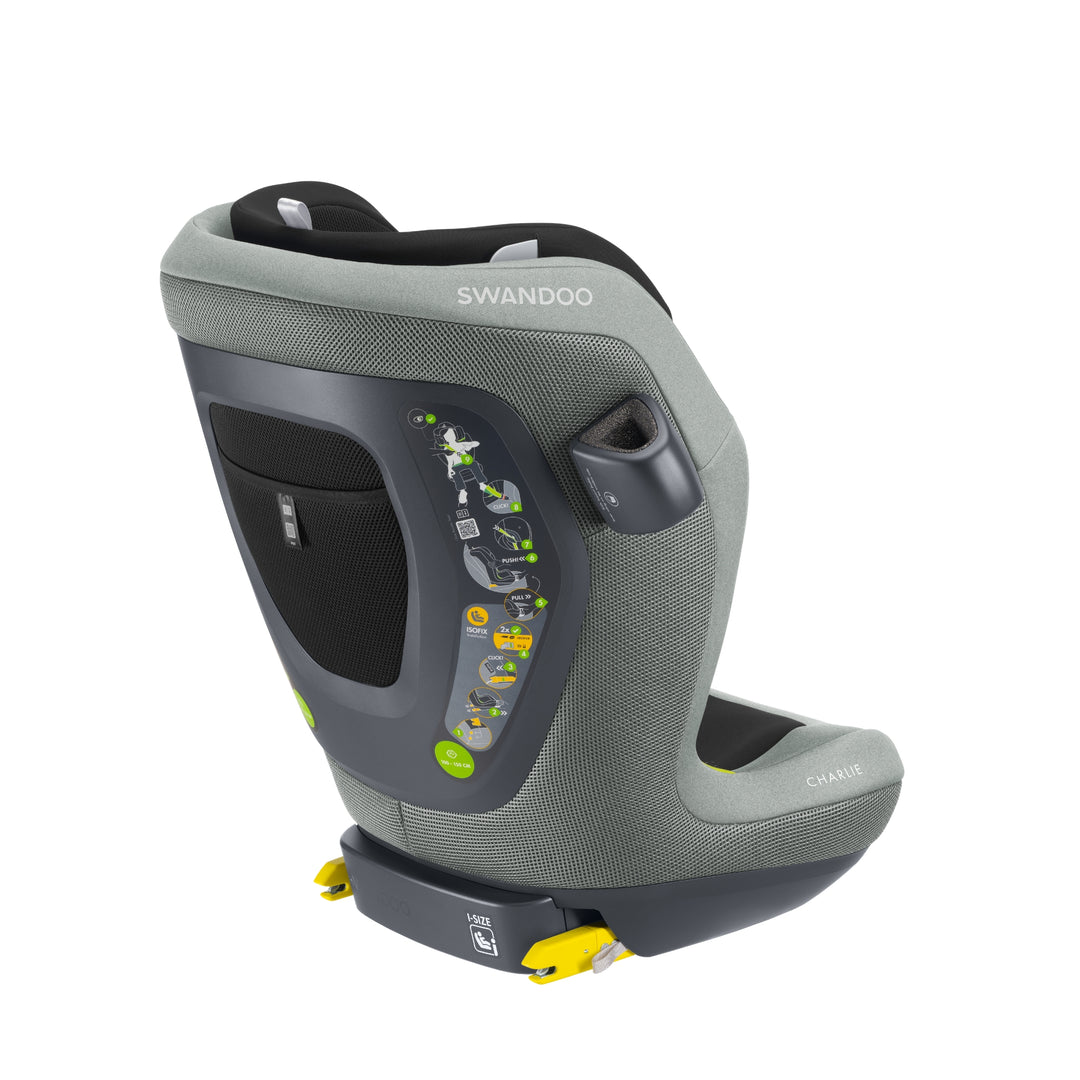 Angled view of Swandoo Charlie i-Size child booster seat in Groovy Green featuring ergonomic design and ISOFIX installation.