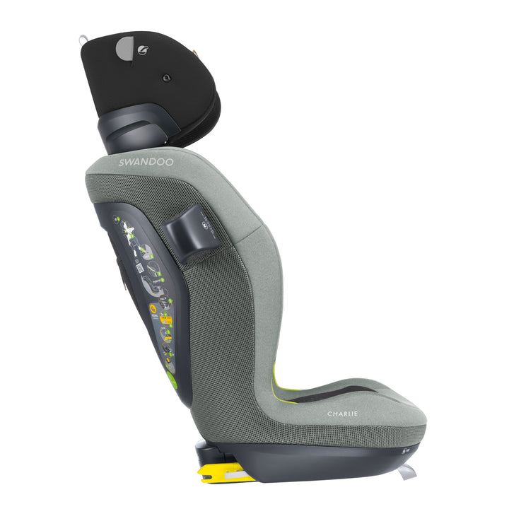 Side profile of Swandoo Charlie i-Size child booster seat with raised headrest and ergonomic safety design in Groovy Green.