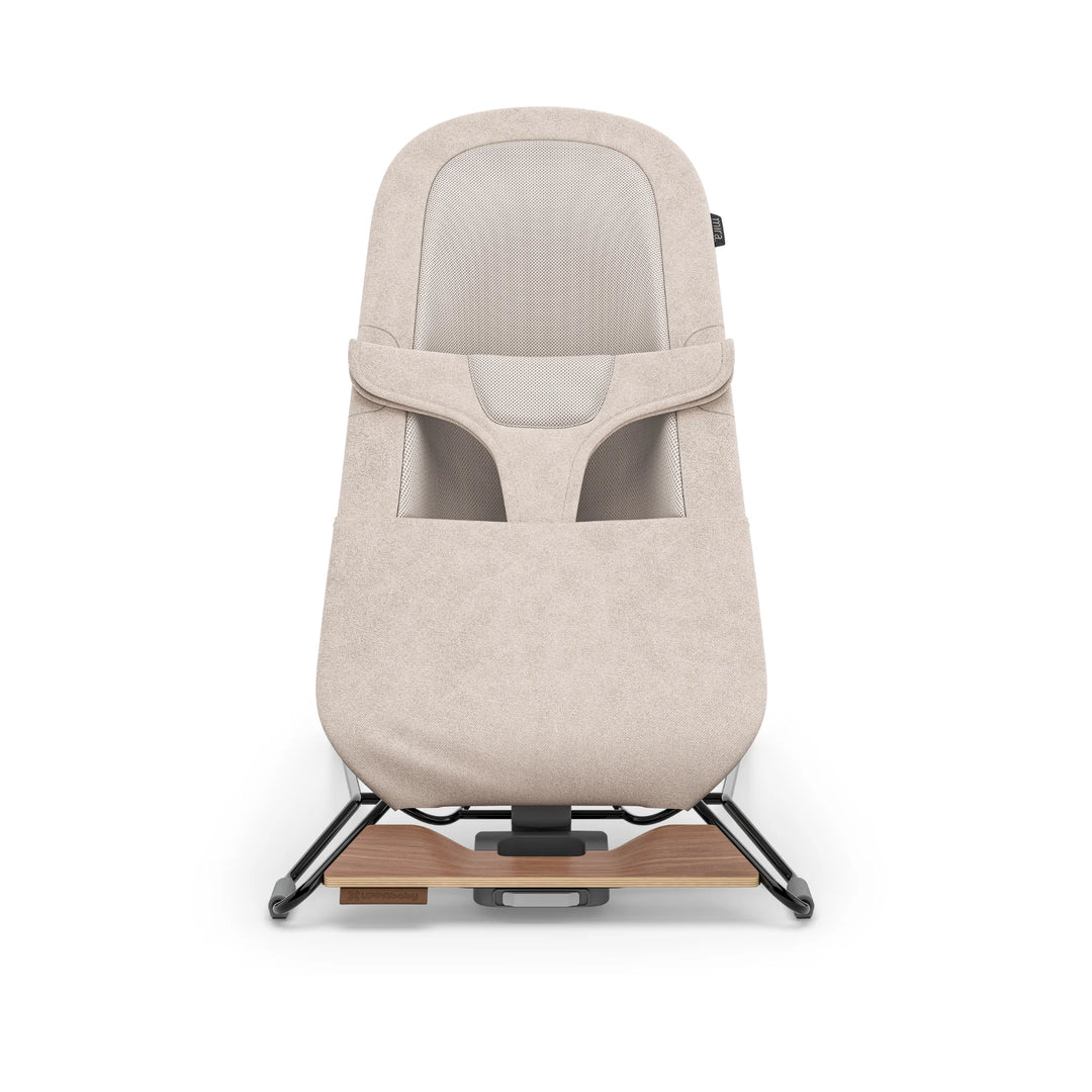 UPPAbaby Mira Bouncer in Charlie fabric shown front-facing on white background, featuring breathable mesh seat, soft textured upholstery, ergonomic infant support and modern minimalist frame with wooden base accent.