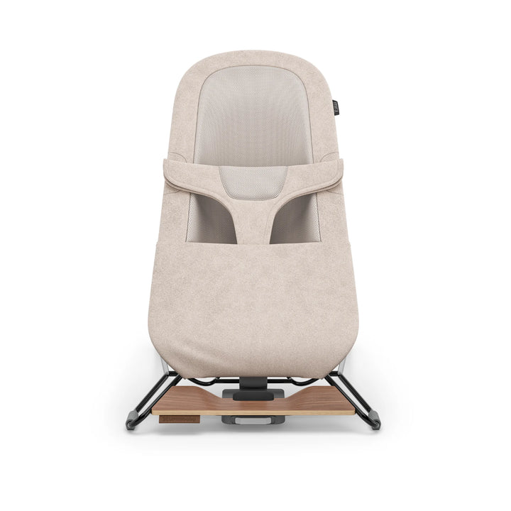 UPPAbaby Mira Bouncer in Charlie fabric shown front-facing on white background, featuring breathable mesh seat, soft textured upholstery, ergonomic infant support and modern minimalist frame with wooden base accent.