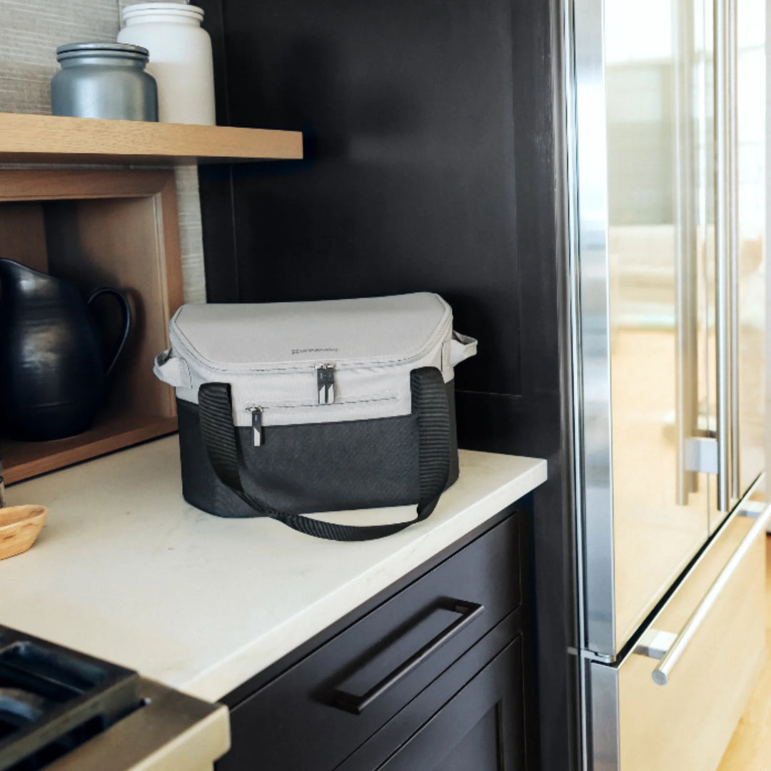 UPPAbaby Bevvy stroller basket cooler box used as an insulated lunch cooler in the kitchen, portable cooler bag for keeping food and drinks fresh on the go.
