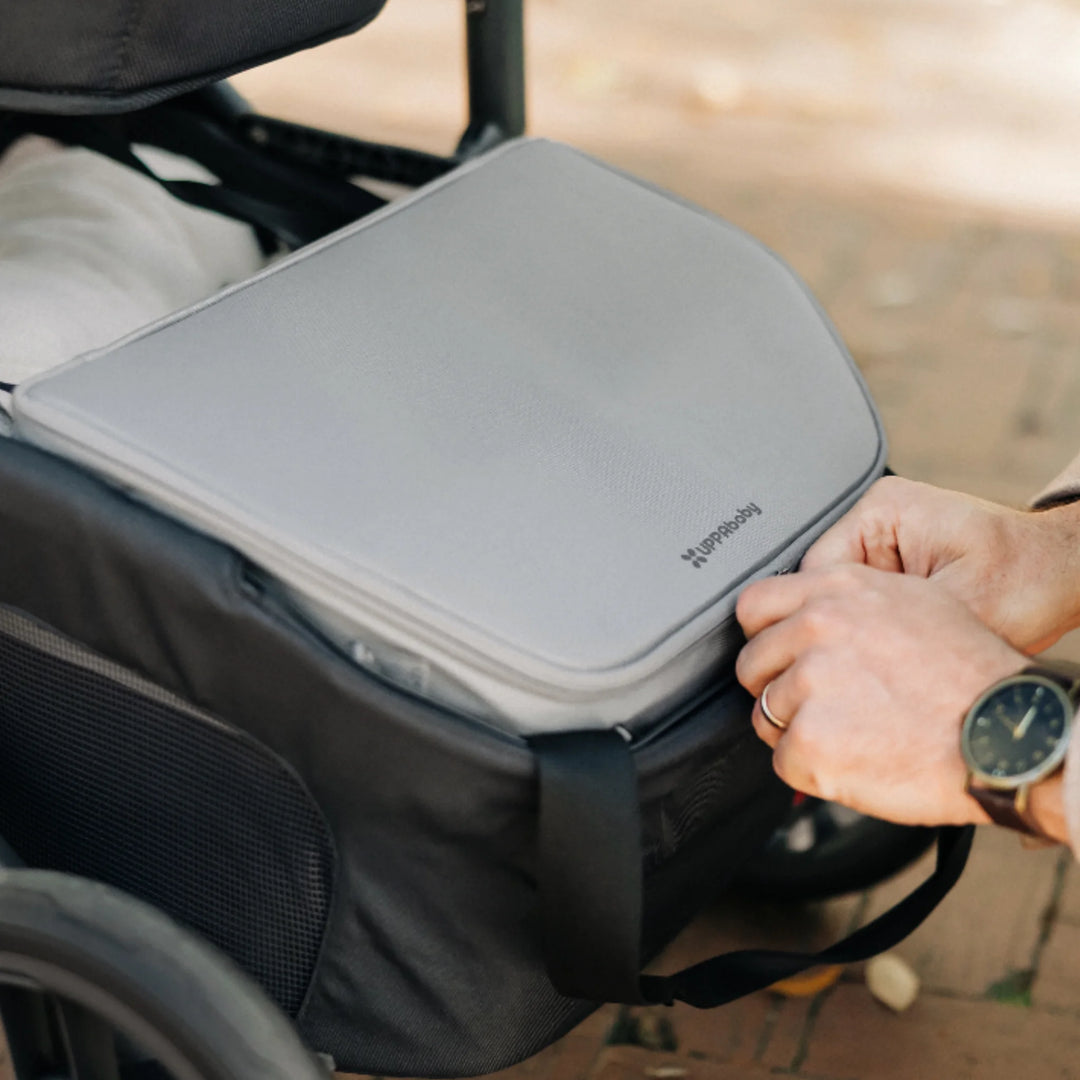 UPPAbaby Bevvy stroller basket cooler box shown inside pushchair basket, insulated cooler bag with zip lid designed to keep food and drinks cold on the go.