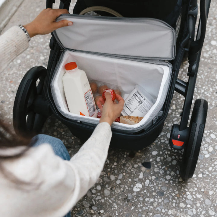 UPPAbaby Bevvy stroller basket cooler box opened inside pushchair basket, insulated cooler keeping drinks and snacks cold while out walking with baby.