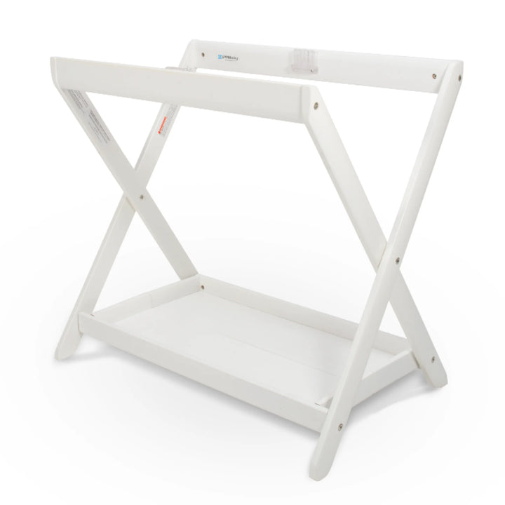 UPPAbaby Carrycot Stand in white finish, a sturdy foldable bassinet stand with cross-frame design and lower storage tray compatible with all UPPAbaby carrycots.