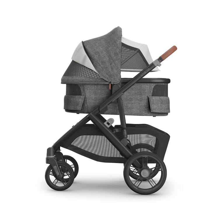 This image shows the Carrycot V3 in Greyson with the sunshade down and vents open on the stroller chassis.