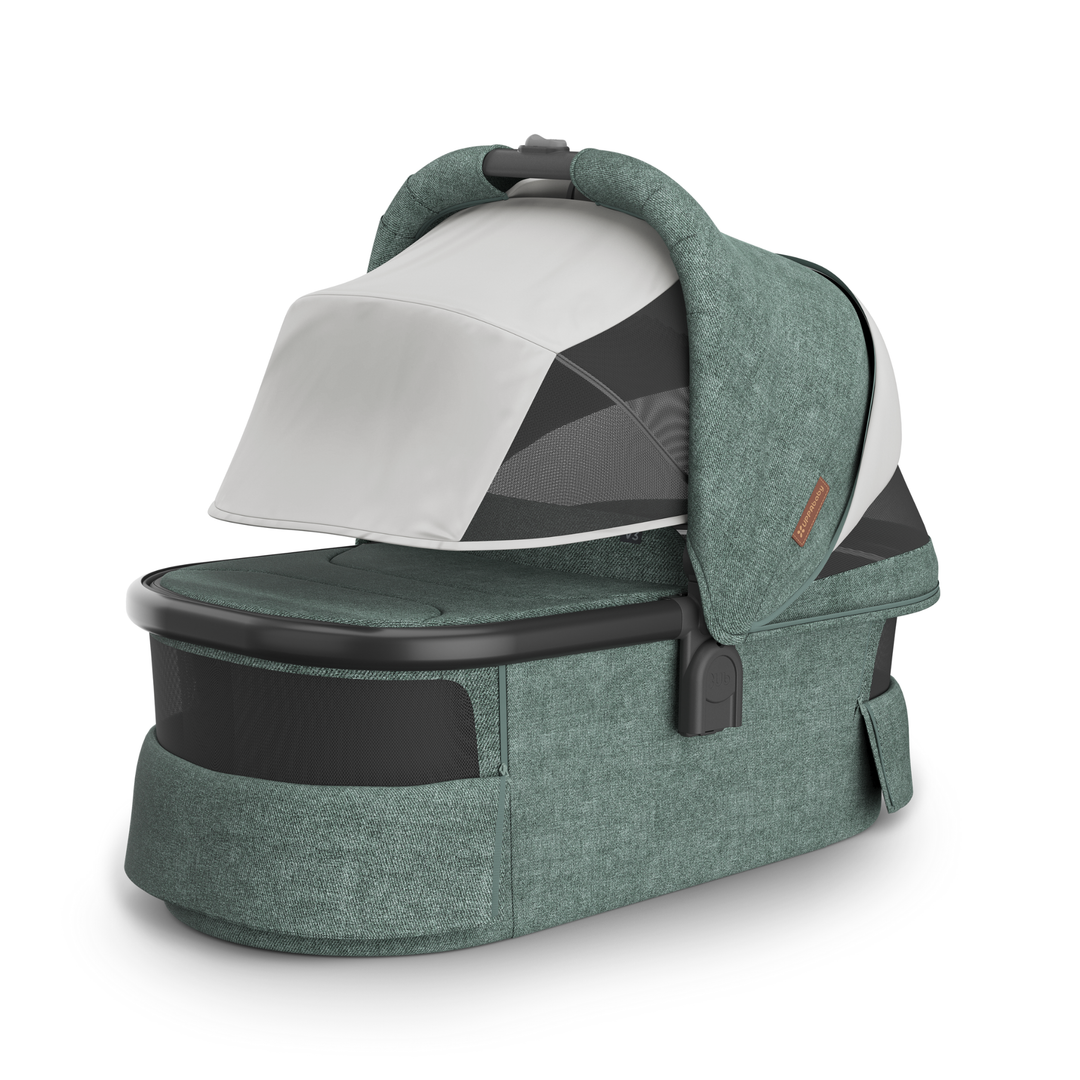 This image shows the Carrycot V3 in Gwen with the sunshade and vents down.