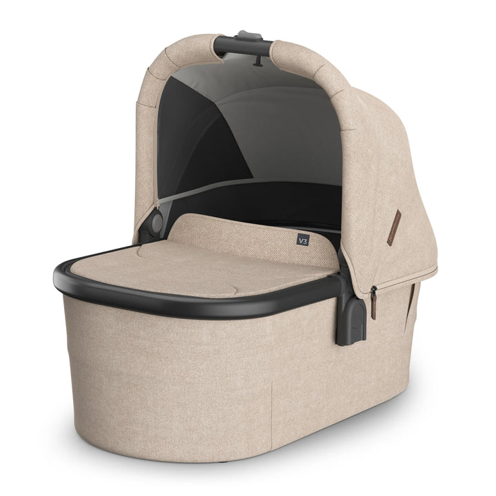 UPPAbaby Vista V3 carrycot in the Liam oatmeal colourway, featuring a ventilated canopy, soft padded interior, premium woven fabrics, and newborn-ready bassinet design for use on or off the stroller chassis.