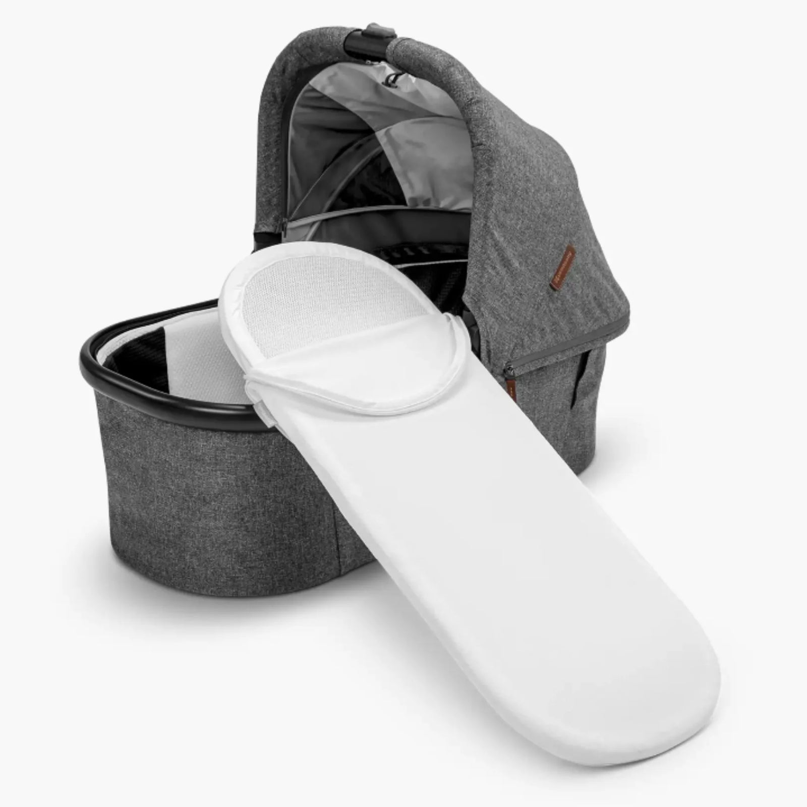 UPPAbaby Carrycot V3 white mattress cover shown fitted, with carrycot in background