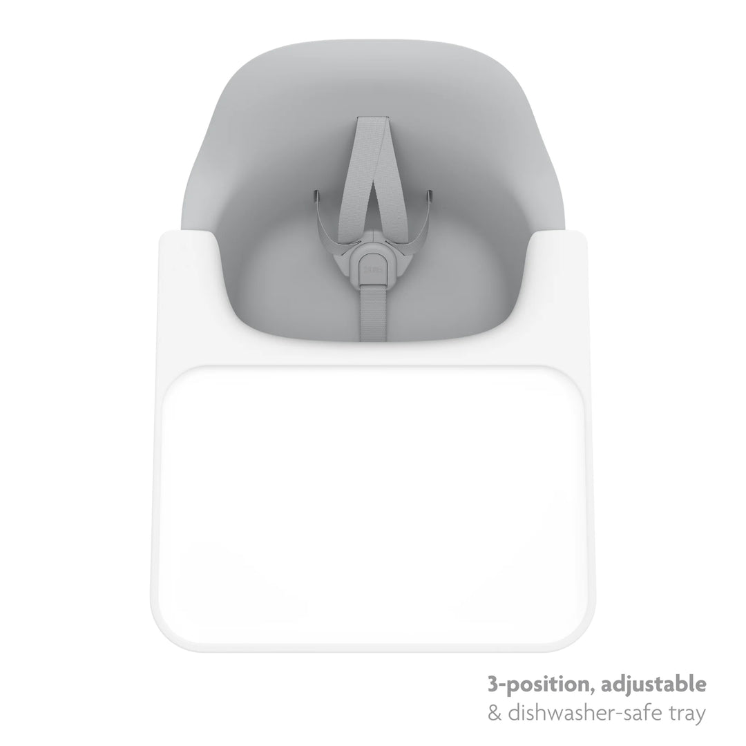 Light grey high chair top down shot of three position, adjustable, dishwasher safe tray on a white background.