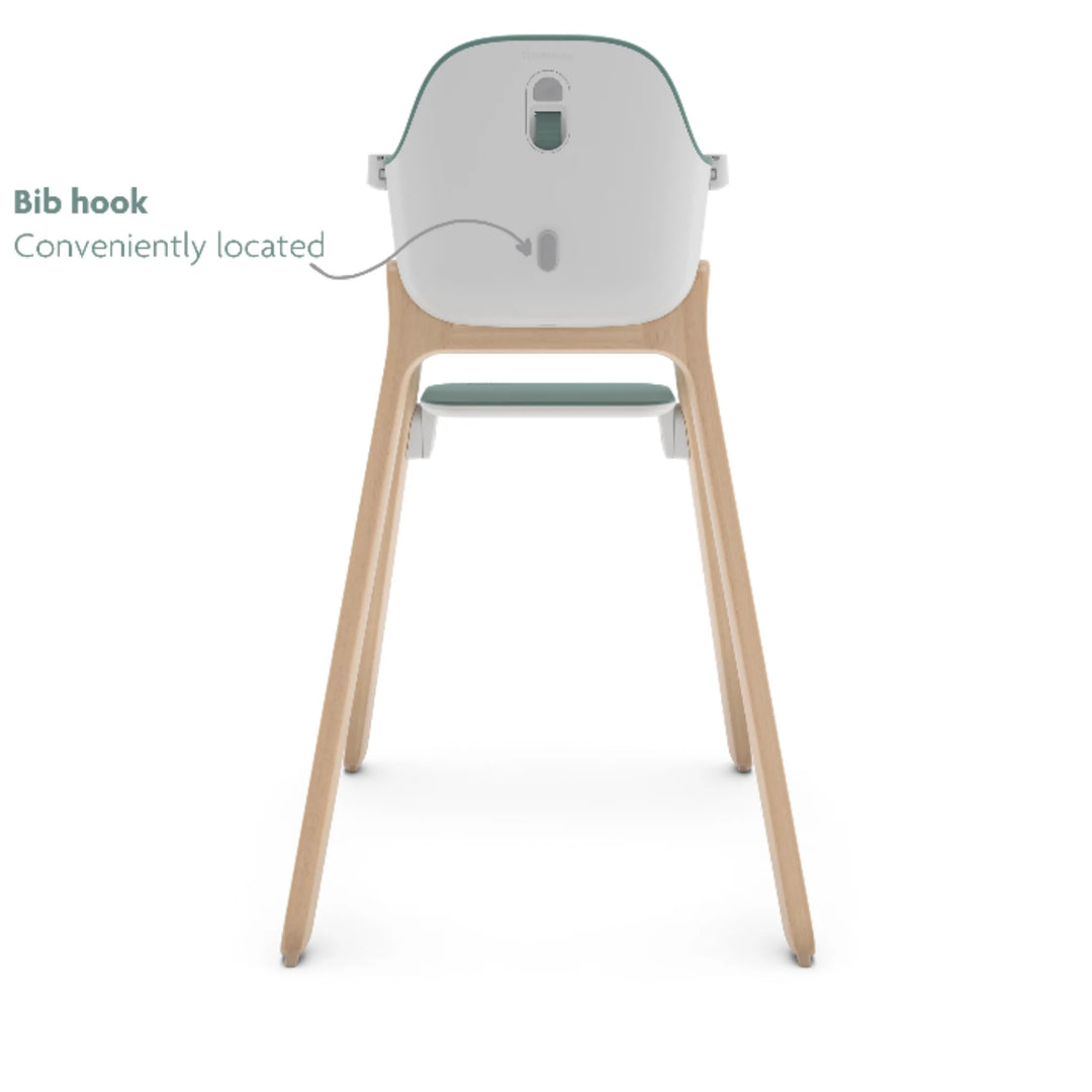 UPPAbaby Ciro High Chair Emrick rear view showing convenient built-in bib hook, modern minimalist baby high chair with wooden legs and green accent seat.