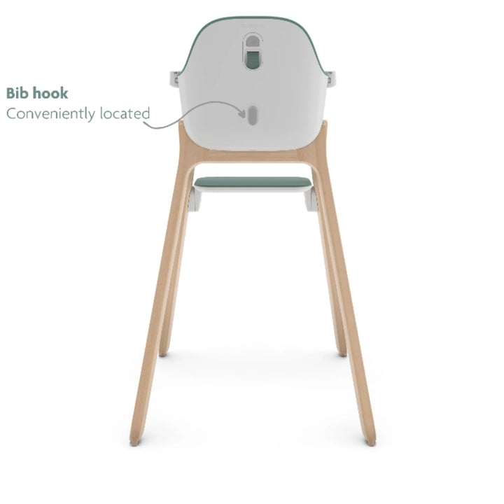 UPPAbaby Ciro High Chair Emrick rear view showing convenient built-in bib hook, modern minimalist baby high chair with wooden legs and green accent seat.
