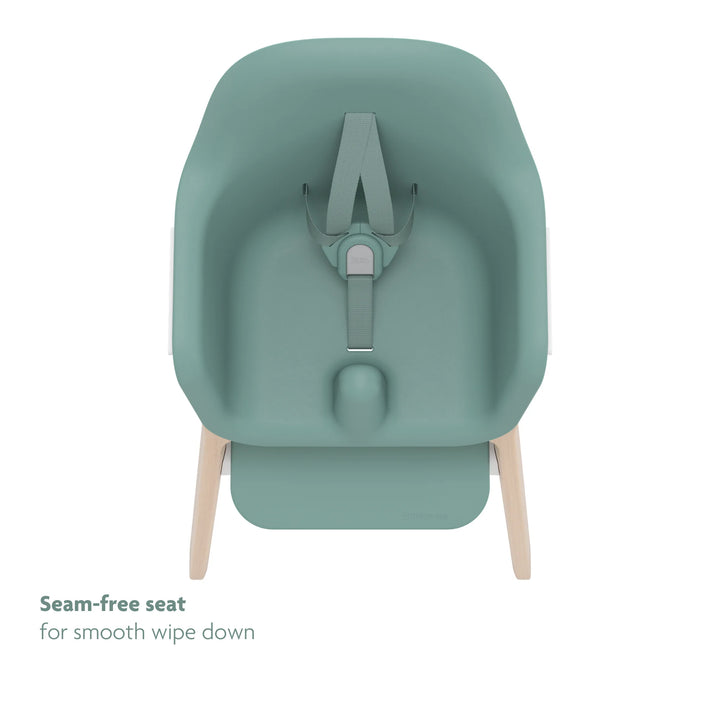 Green high chair top down view of seamless seat and no-rethread adjustable harness on white background.
