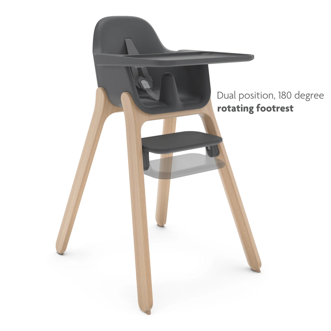 Black and wooden high chair with dual position, 180 degree rotating footrest on a white background.