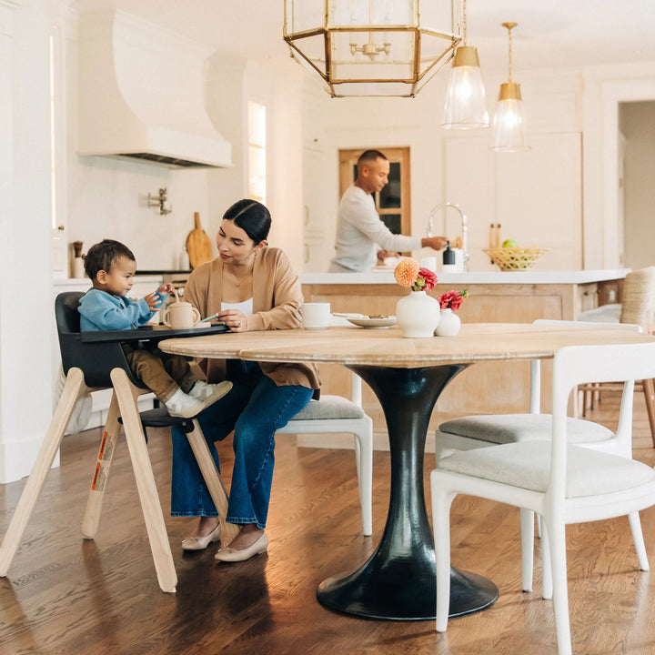 Woman with child at a dining table in a modern kitchen