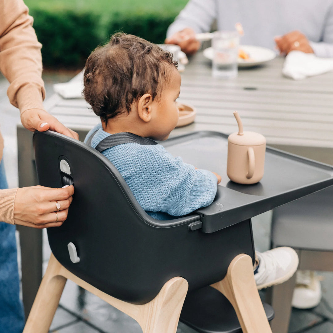 Parent adjusting harness for the Ciro high chair at the back.