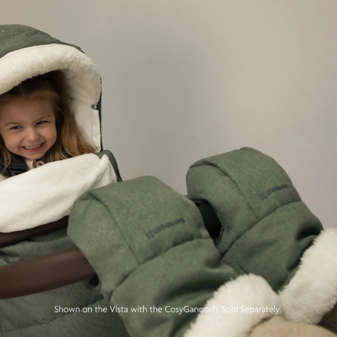 UPPAbaby Cozy Handmuffs Evelyn stroller hand warmers in use with pushchair, featuring soft fleece lining and insulated fabric to keep parents’ hands warm while strolling in cold weather.