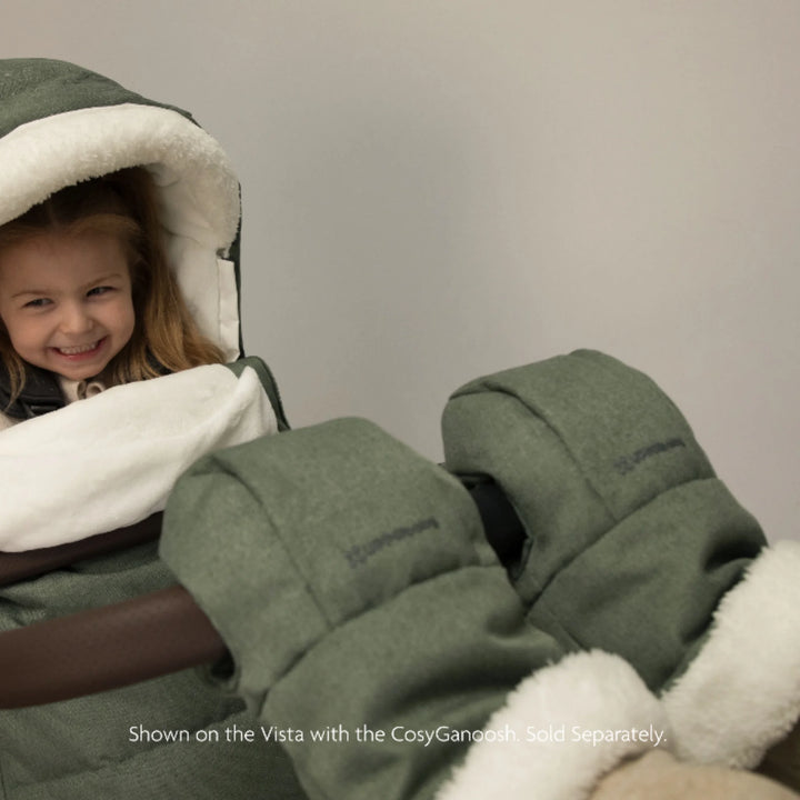 UPPAbaby Cozy Handmuffs Evelyn stroller hand warmers in use with pushchair, featuring soft fleece lining and insulated fabric to keep parents’ hands warm while strolling in cold weather.