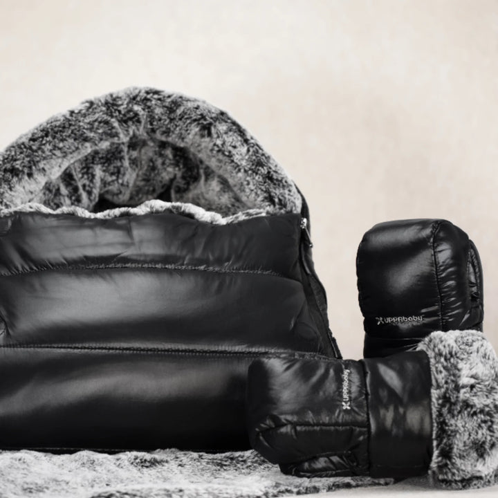 UPPAbaby Cozy Handmuffs Luxe with matching footmuff, black stroller accessories featuring plush faux-fur lining and insulated, weather-resistant fabric for winter pram comfort.