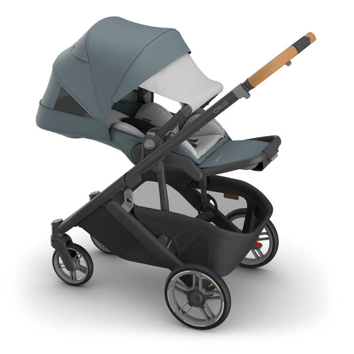 Cruz V3 stroller with gray canopy and black frame on a white background