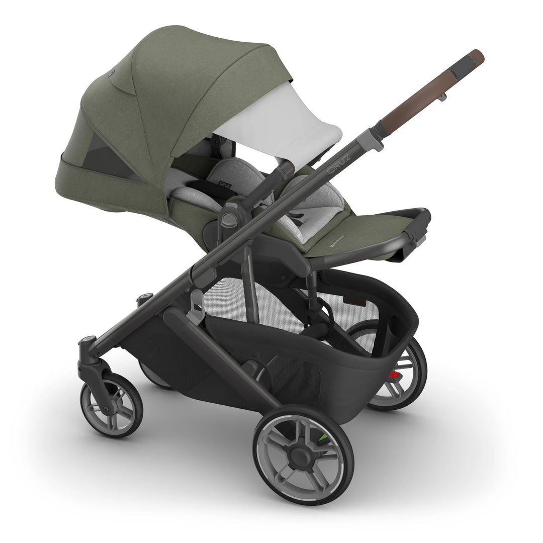 Green and black stroller on a white background with pop-out sun canopy