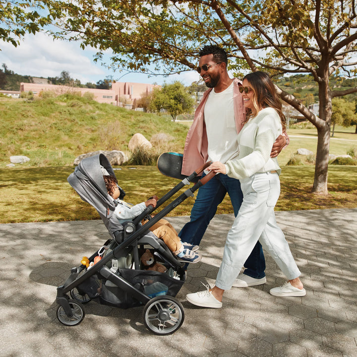 Family walking through a park with the Cruz V3.