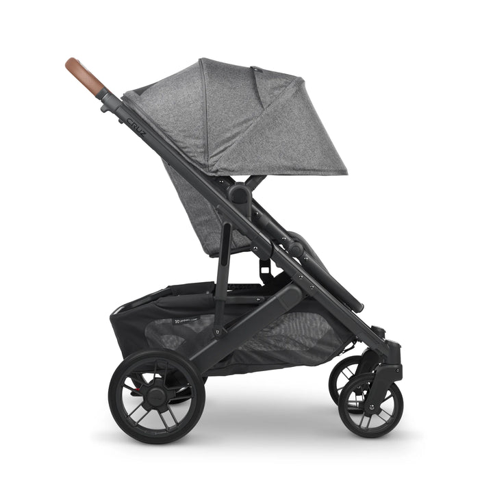 UPPAbaby Cruz V2 Greyson stroller side view – grey lightweight pushchair with extended sun canopy, leather handlebar, and spacious storage basket for modern family travel.